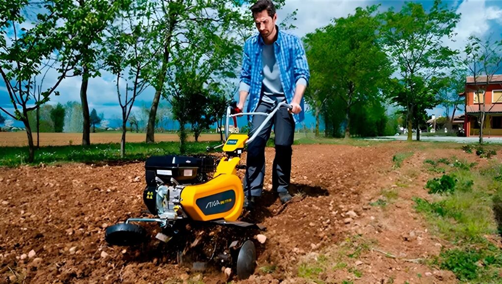 Hombre arando su huerto con una motoazada